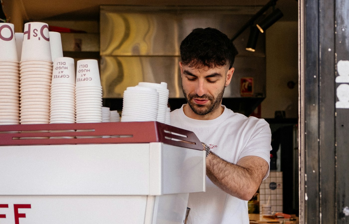Barista working in a Melbourne cafe, illustrating the operating reality of starting an Australian small business