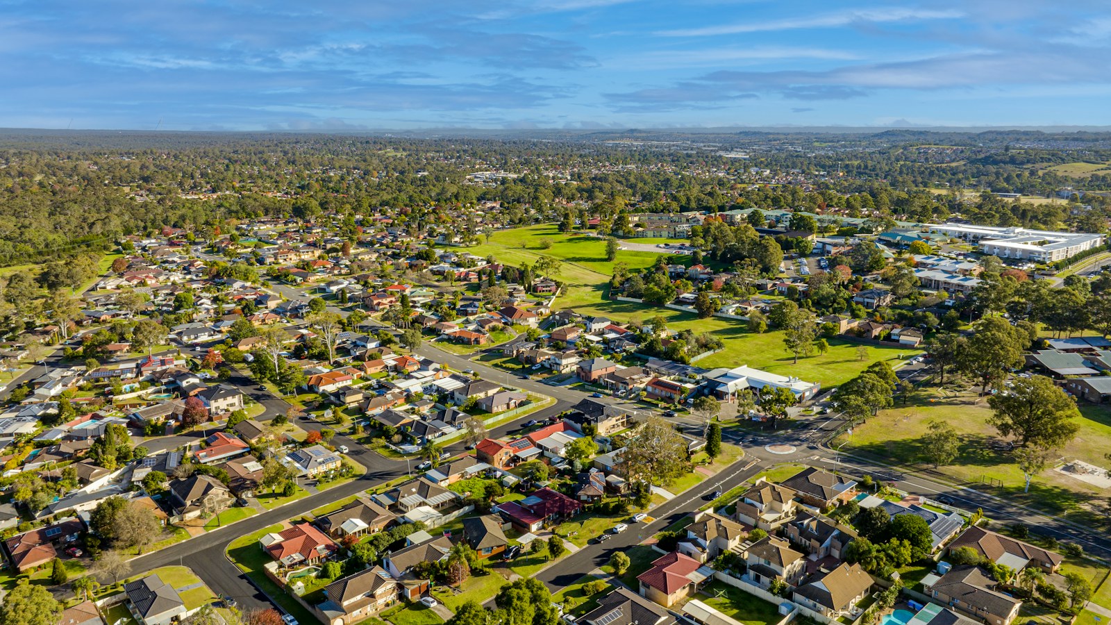 Aerial photograph of a leafy Sydney suburb with Australian homes and streets, illustrating Equity Tap property security